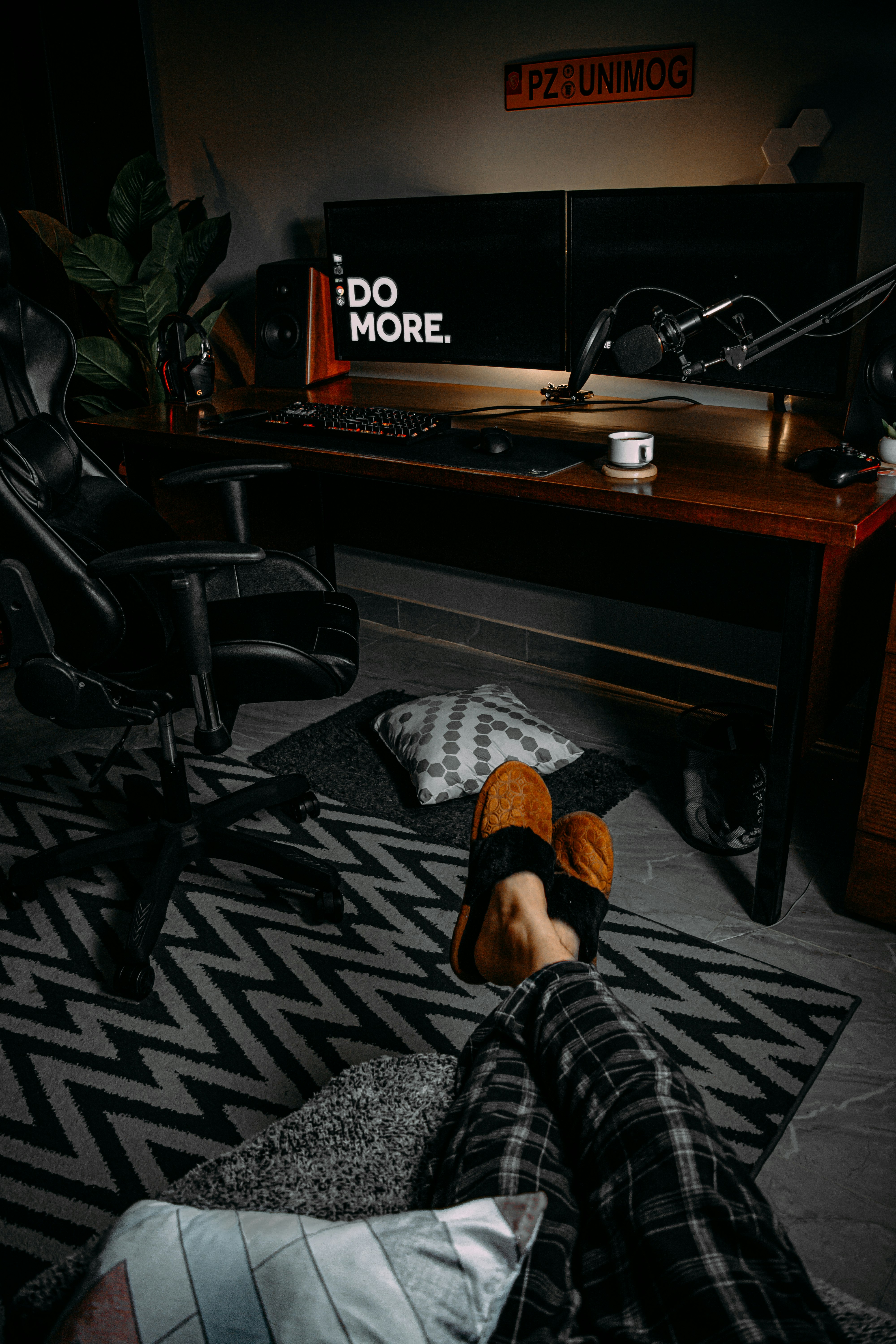 person in black and white plaid pants sitting on black office rolling chair